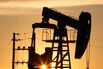 A CNPC "nodding donkey" oil pump pumps oil at sunset in an o