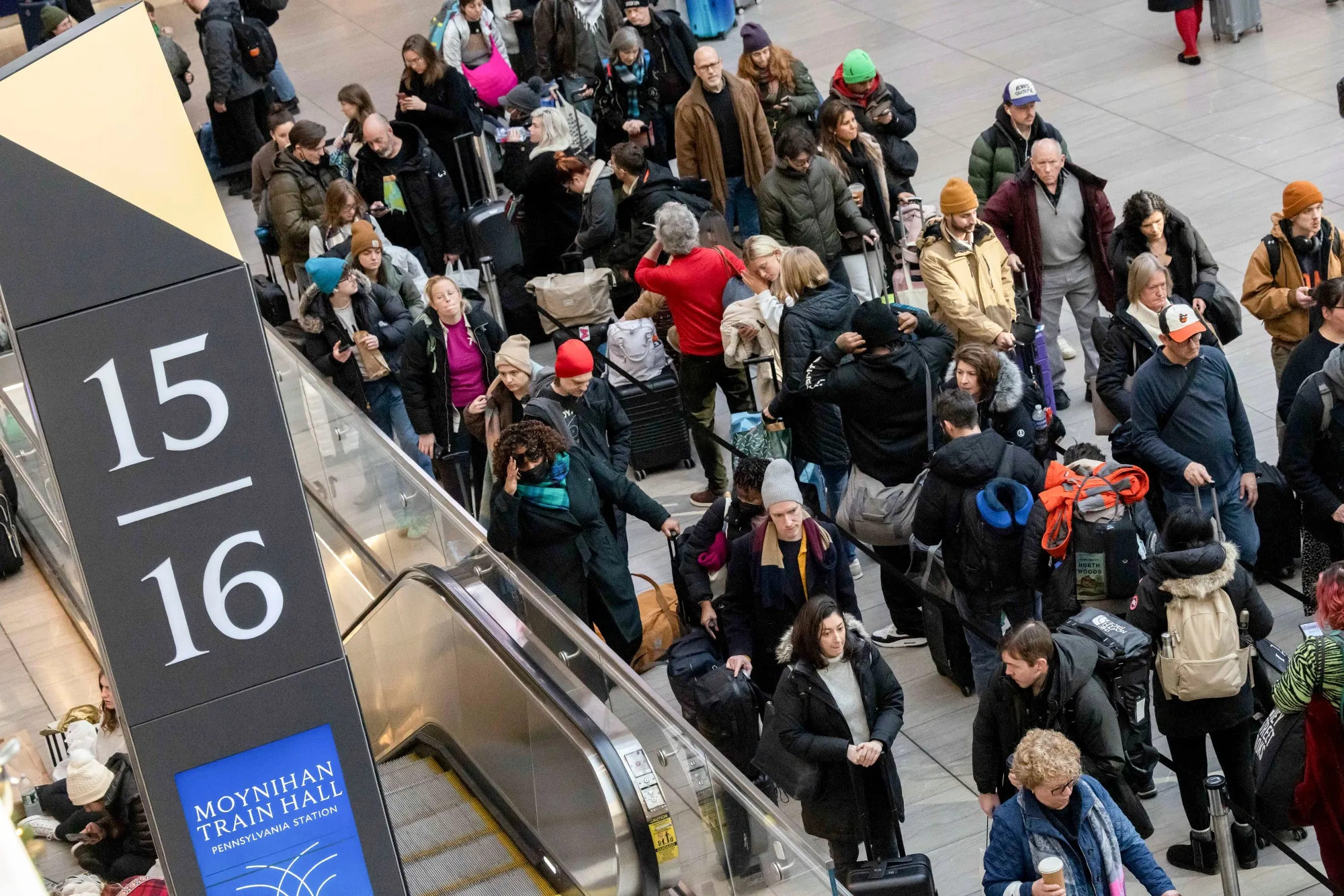 Commuters wait in Moynihan Train Hall at Penn Station in New York.