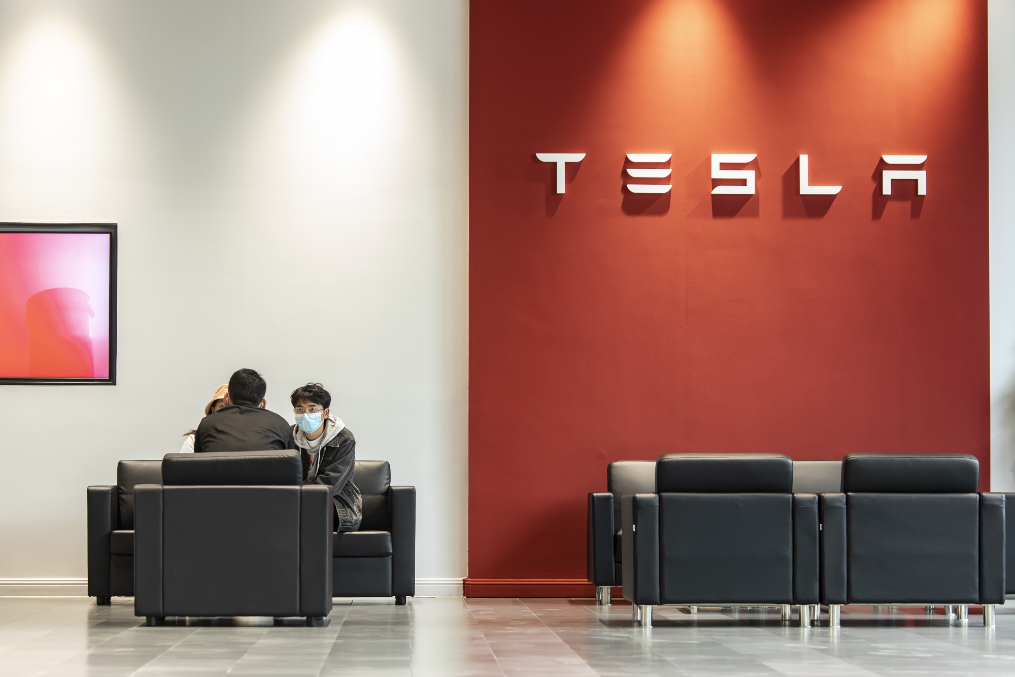 Customers at a Tesla showroom.