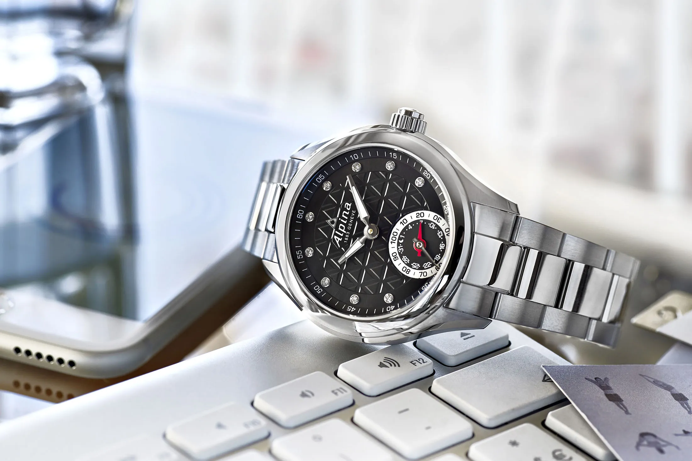 An Alpina smartwatch, with diamonds and a steel bracelet.
