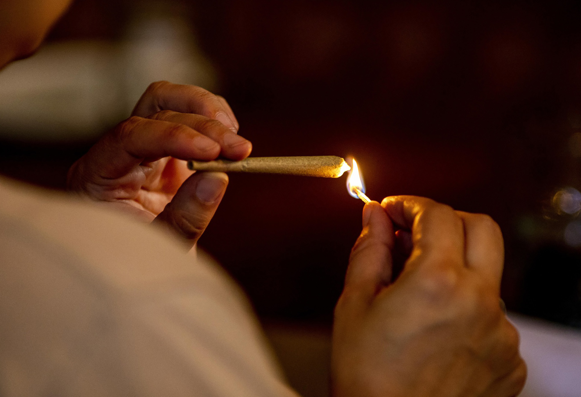 A person lights a joint&nbsp;in West Hollywood, California.