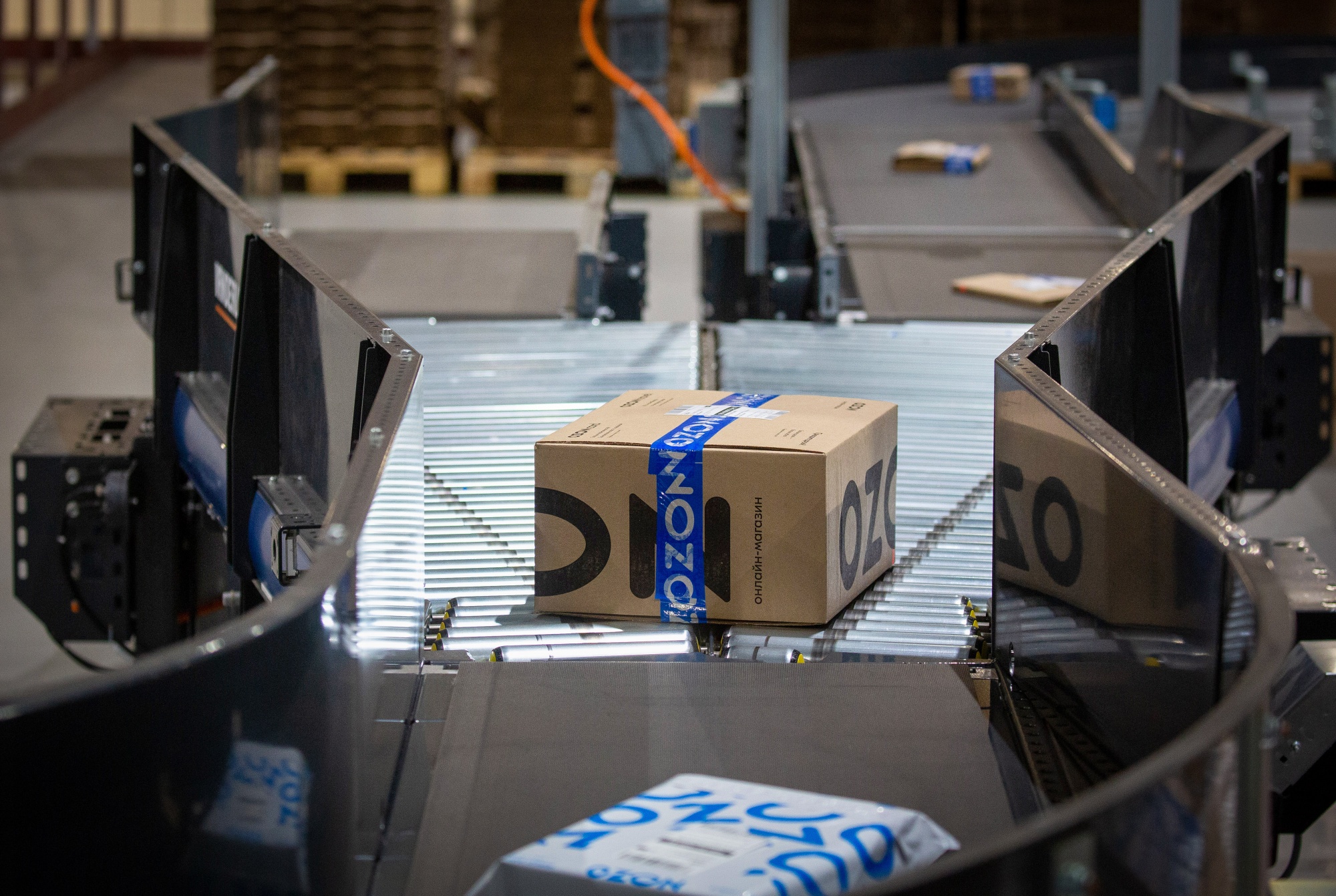 Packaged orders move along a conveyor belt at an Ozon fulfillment center in Horugvino village, outside Moscow.