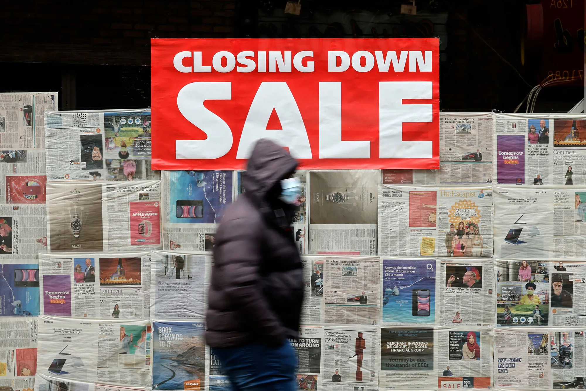 A pedestrian walks past a closed-down store&nbsp;in the City of London.&nbsp;