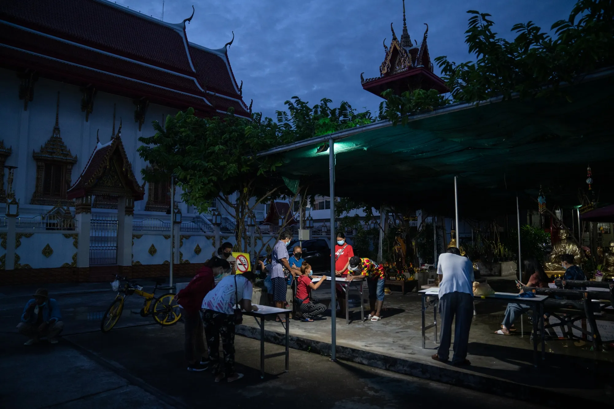 Members of the public register at a Covid-19 testing site set up at Wat Samakkhi Tham in Bangkok,&nbsp; on July 16.