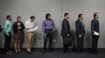 Job seekers wait in line to enter the Choice Career Fair in San Antonio, Texas, U.S., on Thursday, April 16, 2015. Fewer than 300,000 American workers filed applications for unemployment benefits for the sixth consecutive week, pointing to labor-market strength even as hiring cooled last month.
