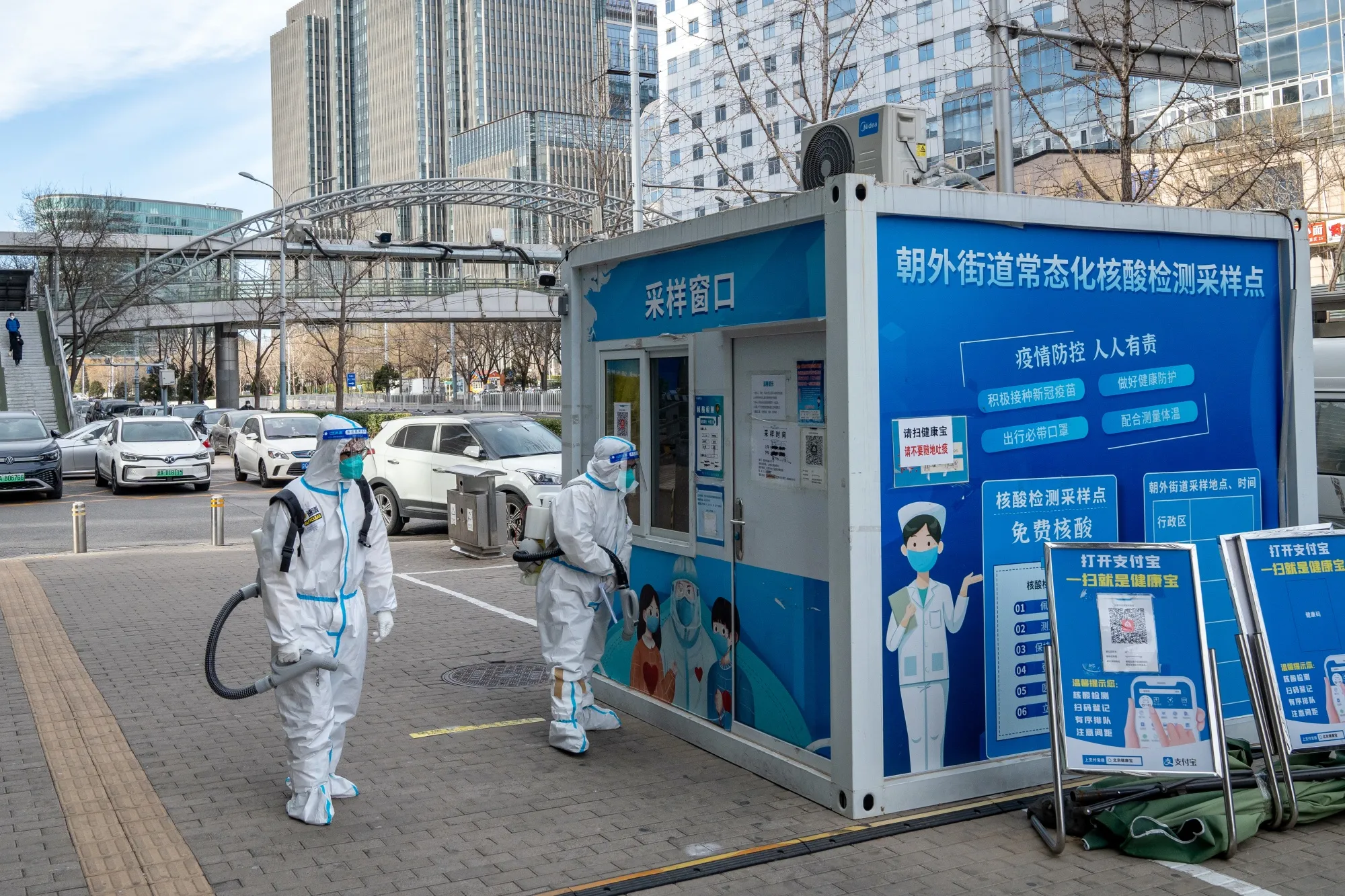 Workers wearing protective gear outside a Covid testing booth in Beijing on Dec. 15.