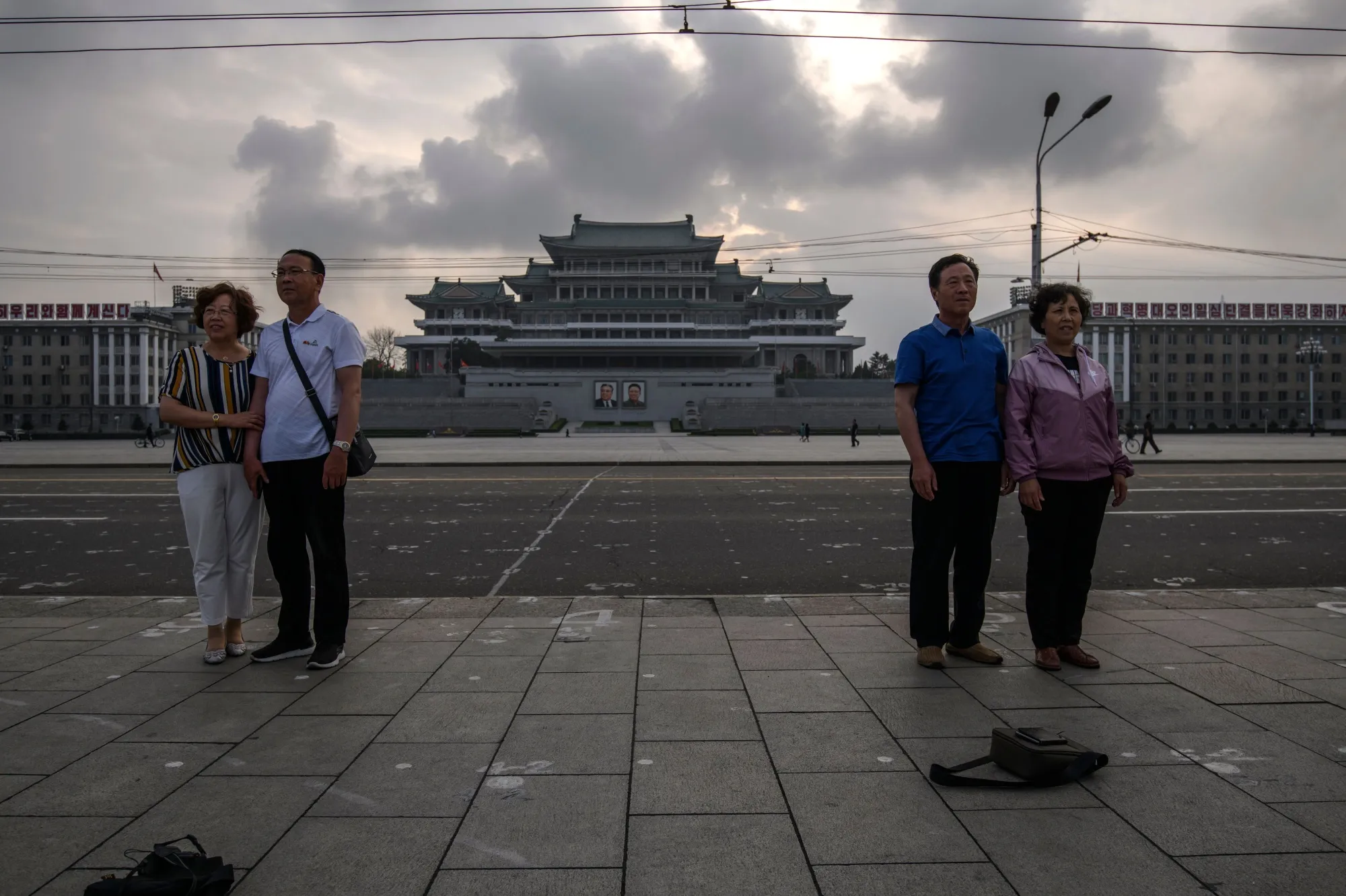Tourists from China pose for photos on Kim Il Sung square in Pyongyang.