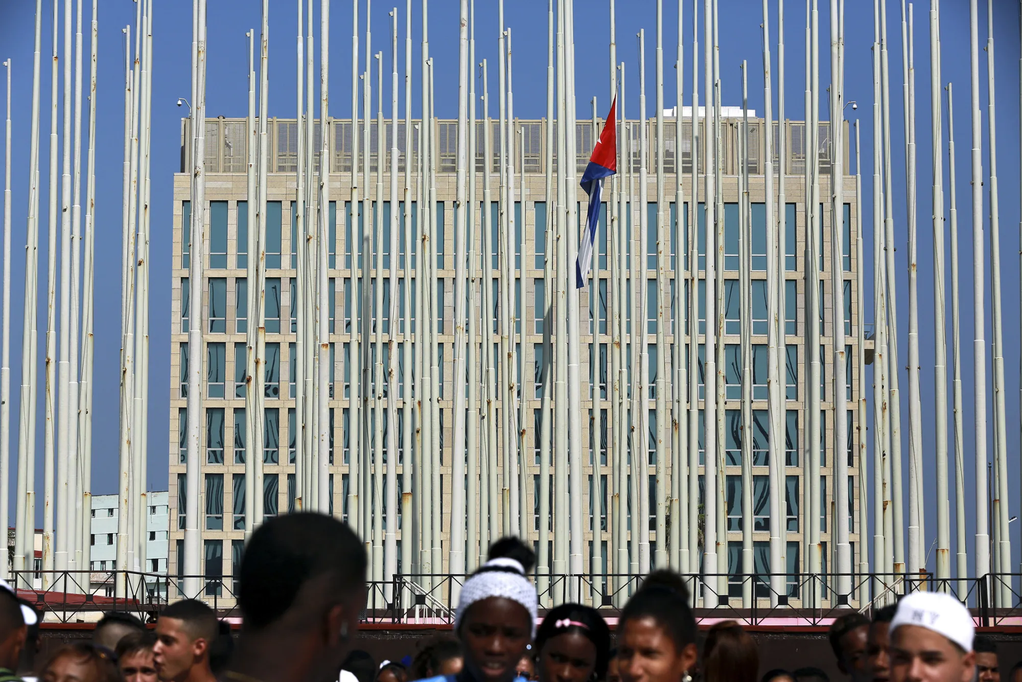 People attend an event honoring young Cuban athletes is held in front of the U.S Interests Section building in Havana, Cuba, on Saturday, June 27, 2015. U.S. President Barack Obama urged Congress to follow his decision to reopen the American embassy in Havana by lifting the U.S. trade embargo on Cuba.
