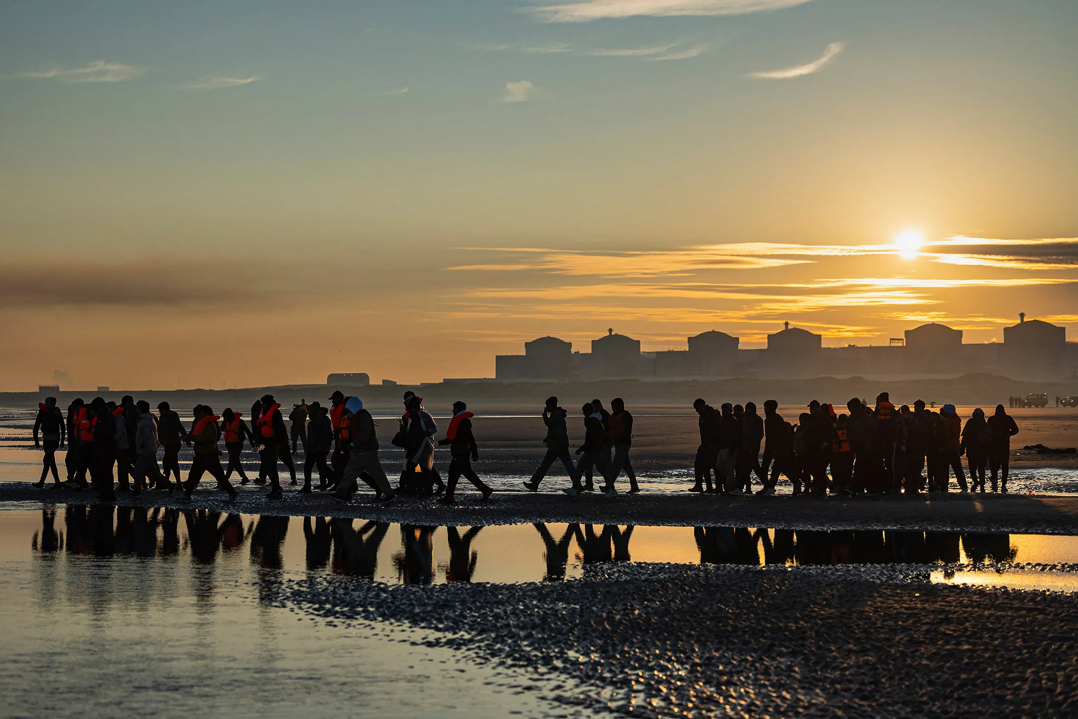 Migrants wade into the sea to try to board smugglers' boats in an attempt to cross the English Channel off the beach of Gravelines, northern France, on Sept.&nbsp;27.