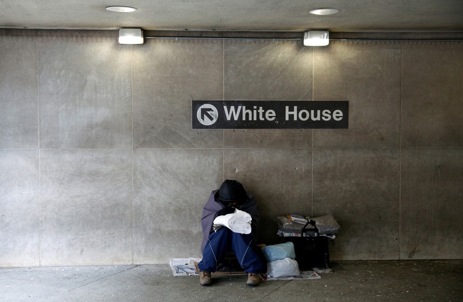 A homeless person tries to stay warm at a subway station near the White House in Washington D.C.