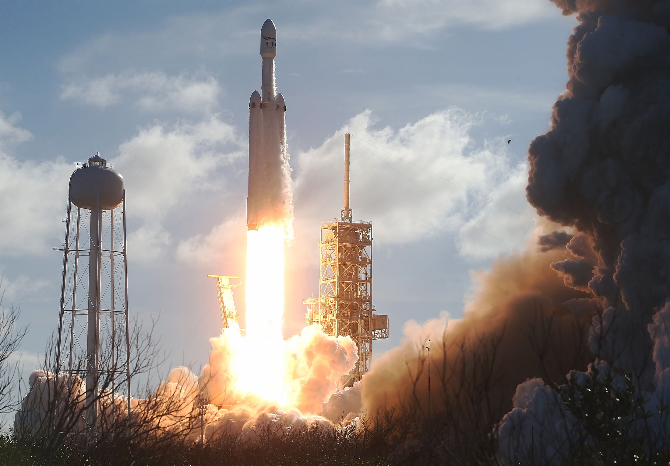 The SpaceX Falcon Heavy rocket lifts off from launch pad 39A at Kennedy Space Center in Cape Canaveral, Fla. on Feb. 6, 2018.