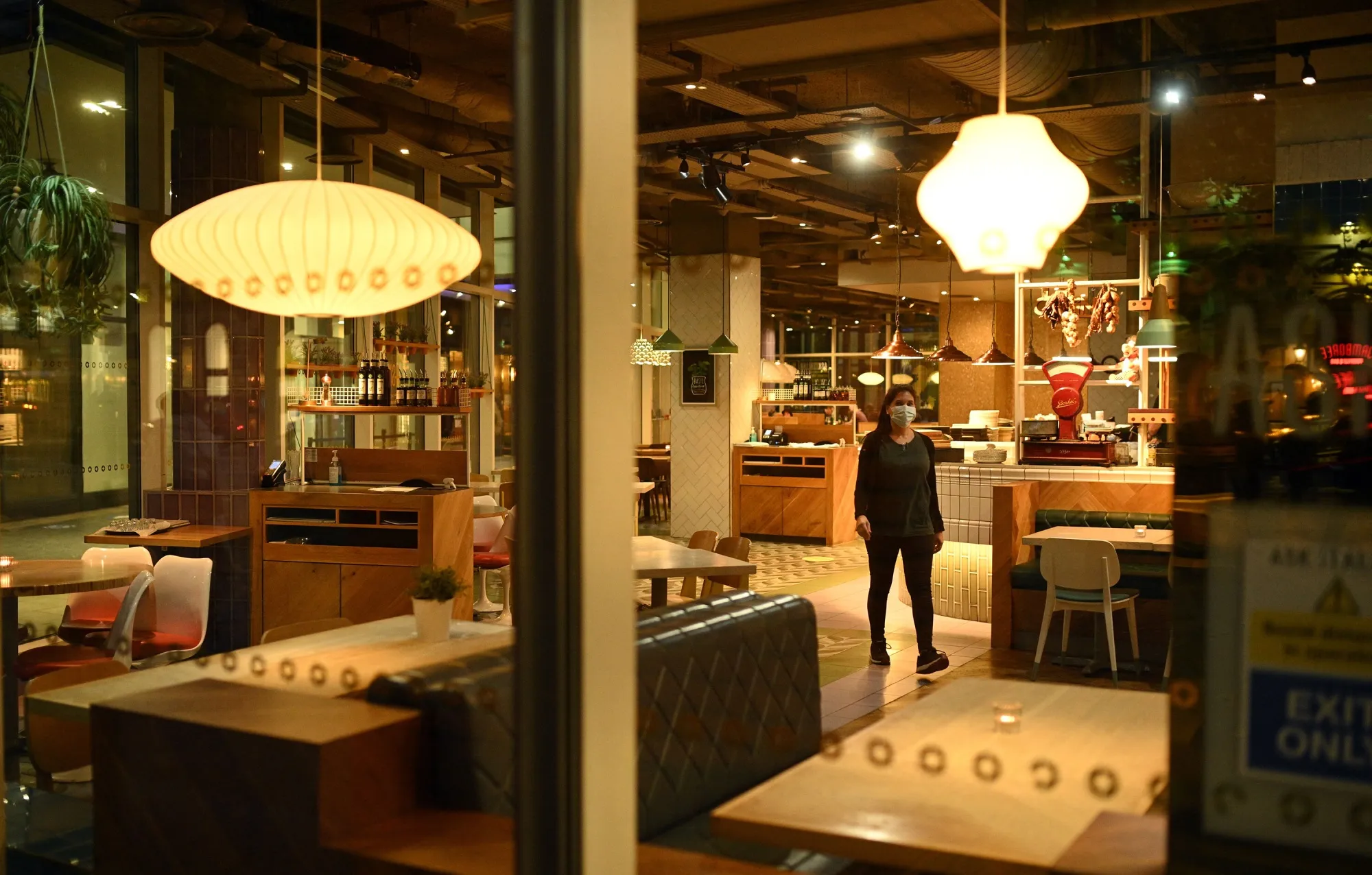 A woman walks through an empty restaurant in&nbsp;Manchester on Oct.&nbsp;8.&nbsp;