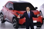 Akio Toyoda, president of Toyota Motor Corp., speaks in front of a prototype of the company's bz series