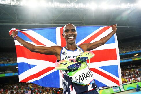 Mo Farah celebrates after winning gold in the men’s 5000 meter final.