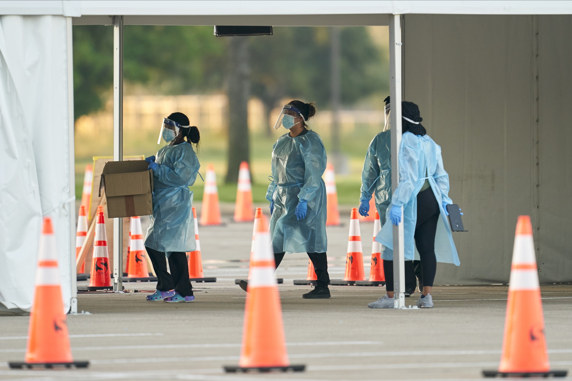 Healthcare workers wearing protective gear prepare to administer swab tests at a Covid-19 drive-thru testing site at Dallas College Eastfield Campus in Mesquite, Texas,&nbsp;on&nbsp;Aug. 18.