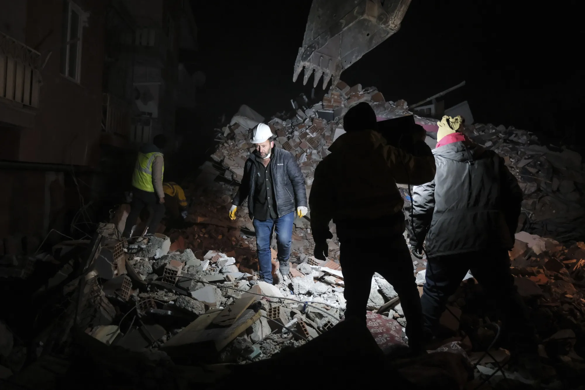 Volunteers search for victims in a ruined building in Elbistan, Turkey, on Feb. 9.