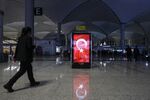 An illuminated advertising board displaying the Turkish national flag stands in the terminal during the official opening ceremony for the new Istanbul Airport in Istanbul, Turkey