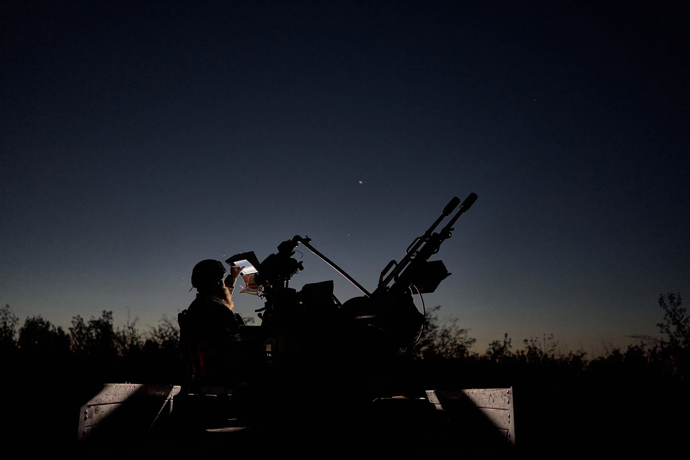 Ukrainian soldiers look for night-flying drones in the Donetsk Region.