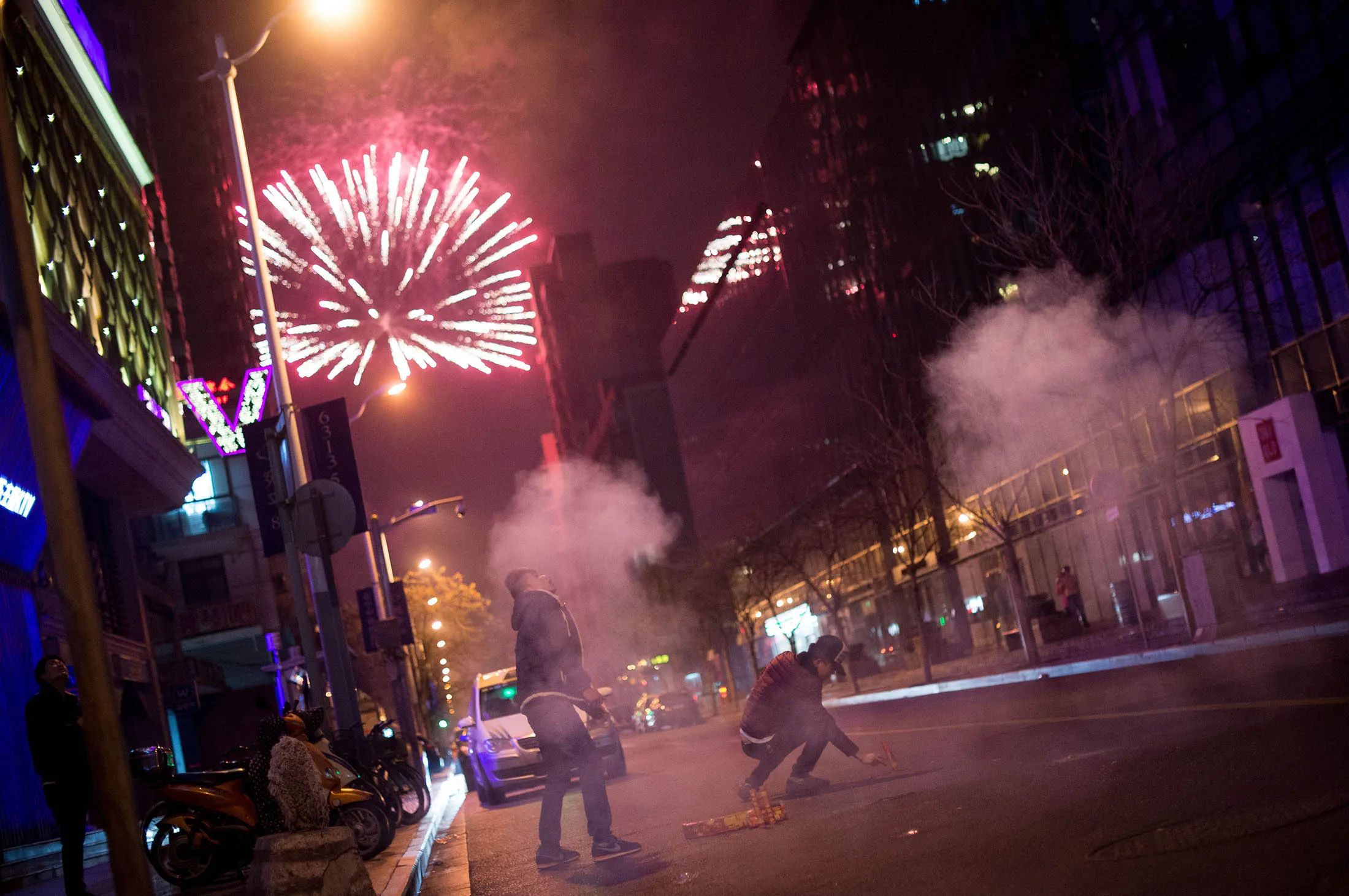 People set off fireworks in a street in Shanghai.
