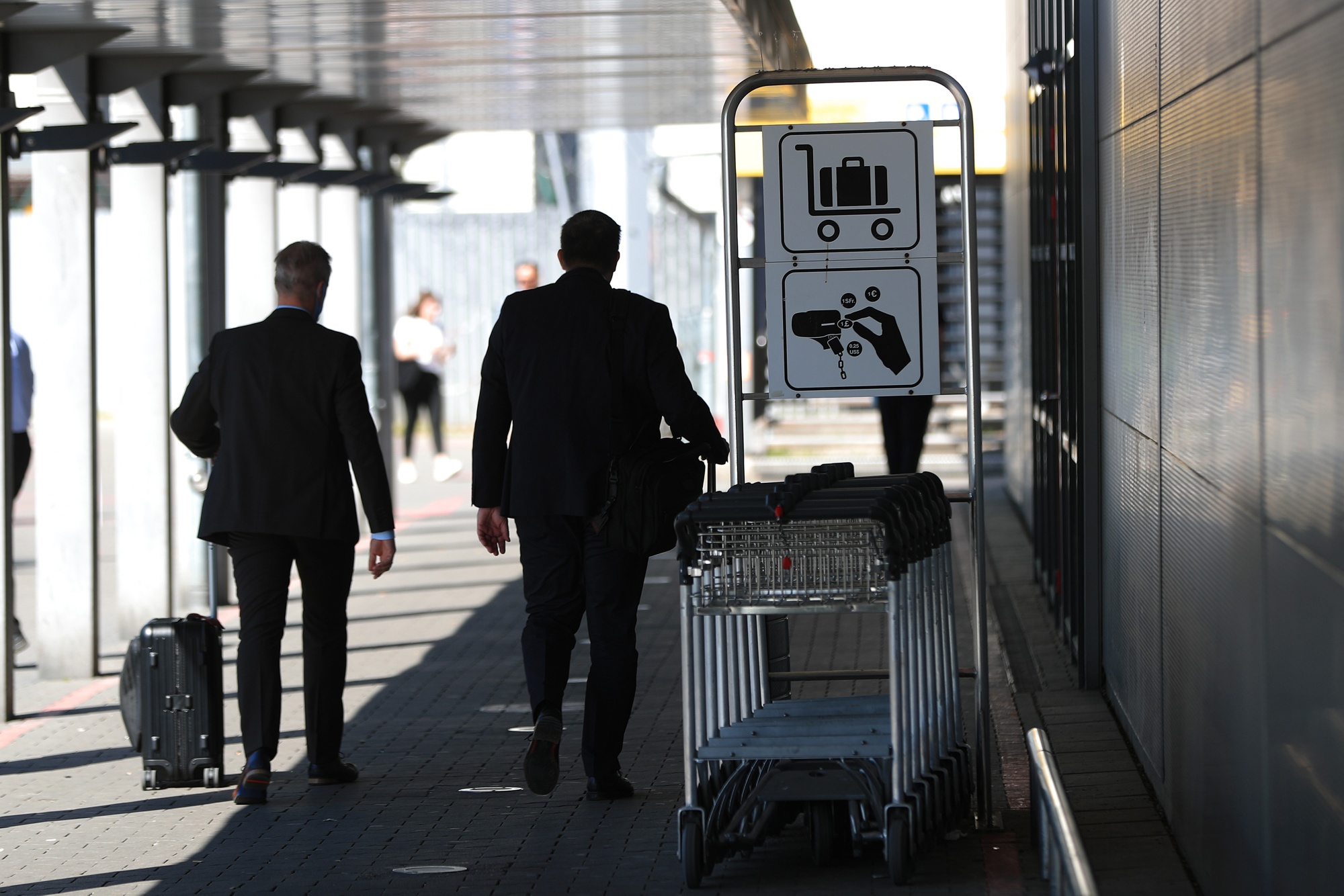Travelers pass a luggage trolley bay outside Tegel airport&nbsp;in Berlin, Germany, on&nbsp;June 2.