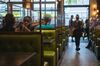 Customers sit at booths separated with plastic protective barriers at a restaurant in Fort Lauderdale, Florida, U.S., on Thursday, June 25, 2020. On Thursday, Florida reported more than 5,000 new confirmed cases of COVID-19 in the state, reported the Associated Press.