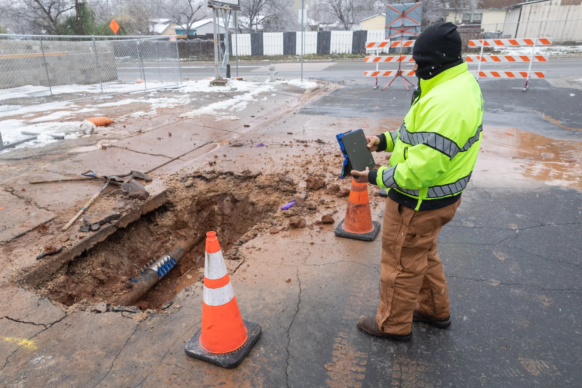 A City of Austin worker surveys a recently mended water pipe after it froze in Austin, Texas, on Feb. 18.