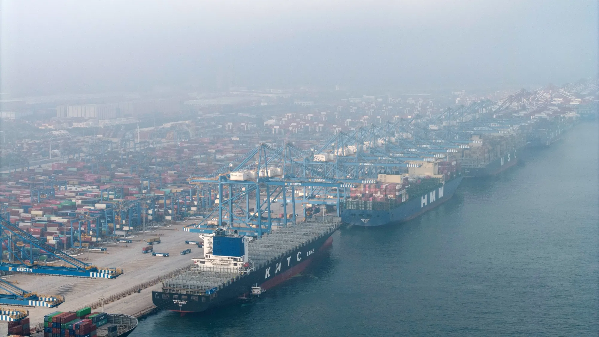 Container ships moored at the Qingdao Port in Qingdao, China.&nbsp;China is set to release data on Monday showing that a historic contraction in investment and faltering consumption are offsetting the momentum given by the export boom.