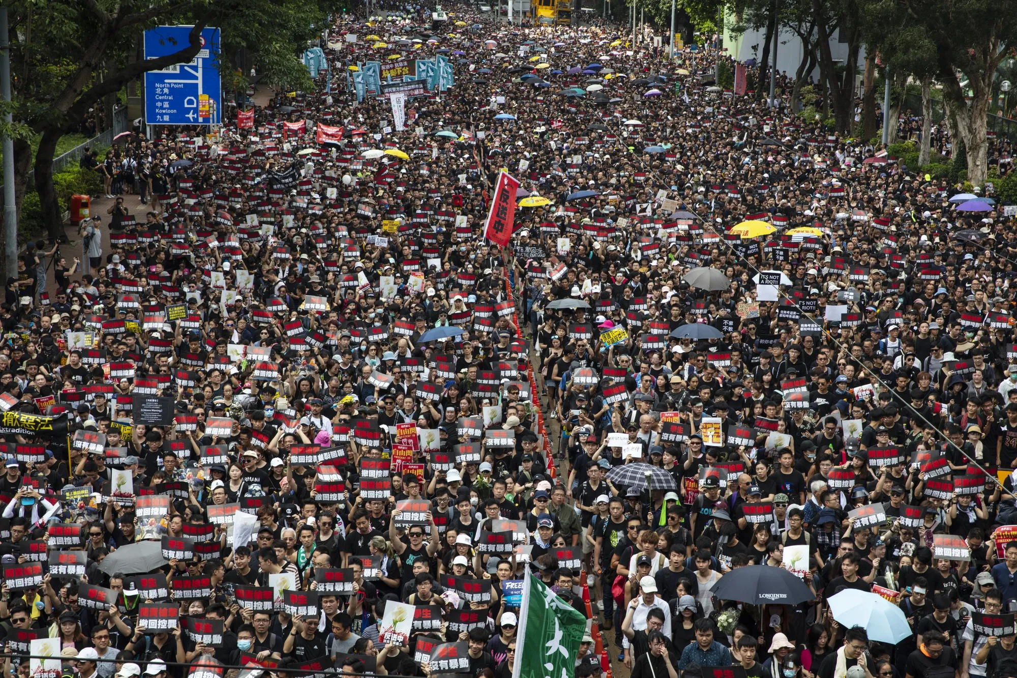 Protesters march during a rally in Hong Kong on Sunday, June 16.