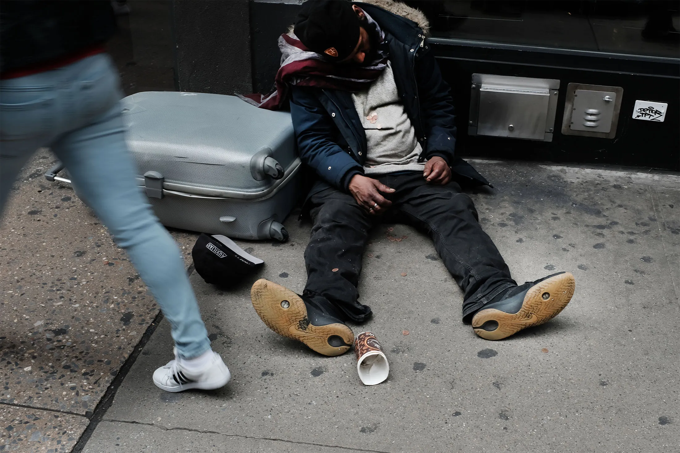 A homeless person sleeps on a sidewalk in New York City on May 17, 2019.