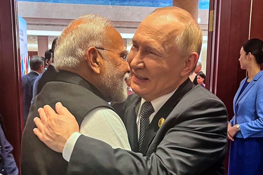 Vladimir Putin, right, hugs Narendra Modi in Tianjin, China, on Sept. 1.