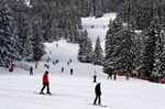 Tourists on ski ride down a slope in the French Alps ski resort of Courchevel.