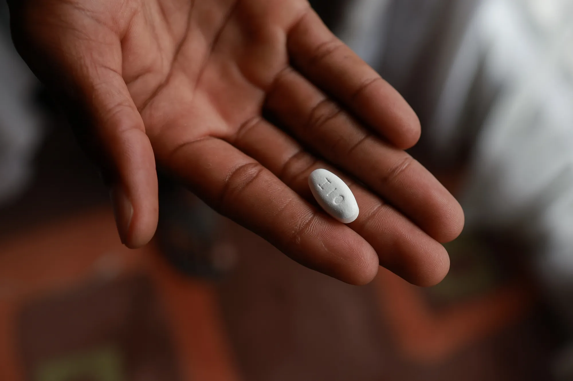 A patient holds a medication used for the treatment of HIV infection in&nbsp;Mbombela, South Africa.&nbsp;