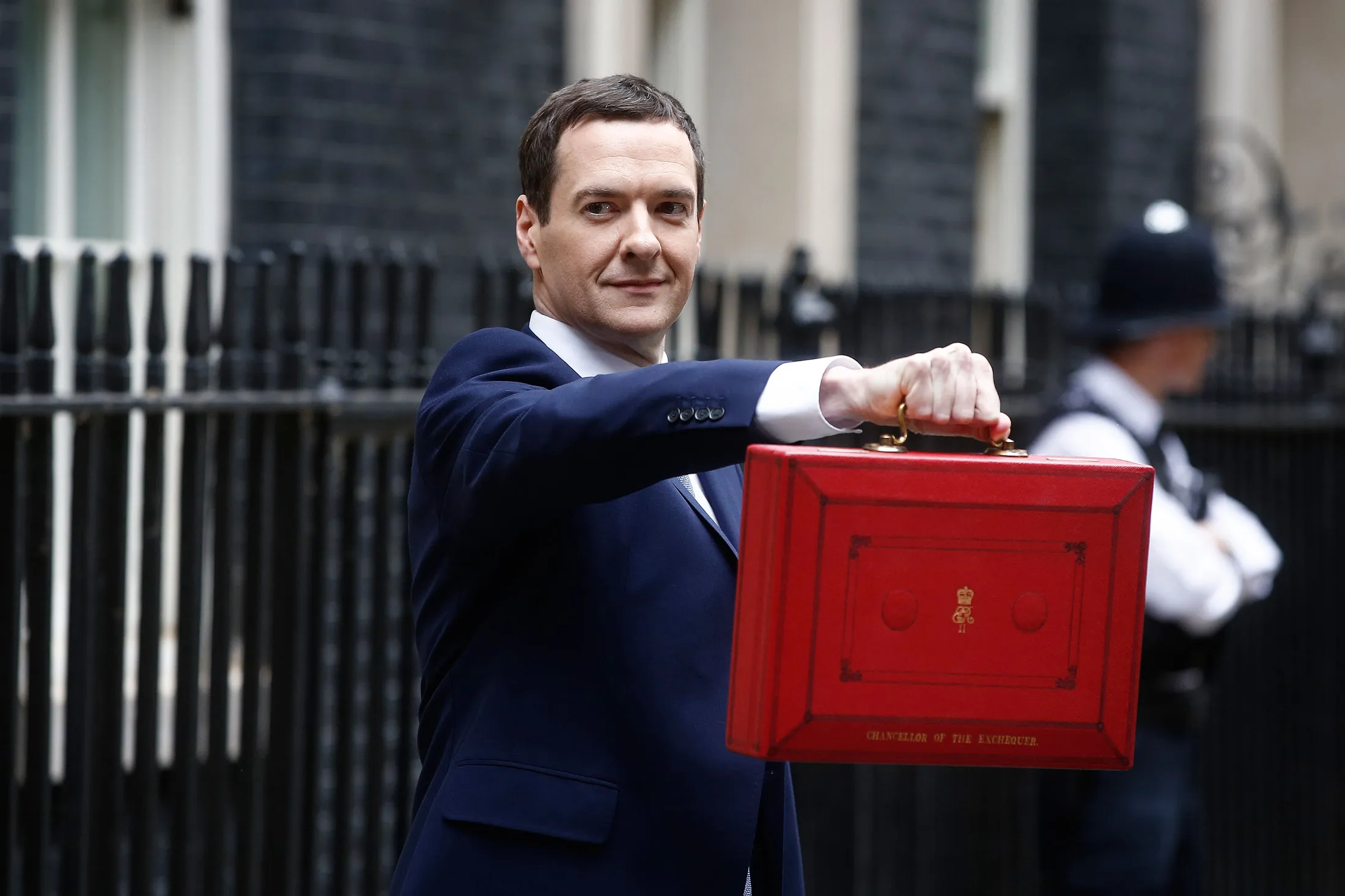 Chancellor of the Exchequer George Osborne holds the dispatch box as he exits 11 Downing Street in London, on July 8, 2015.
