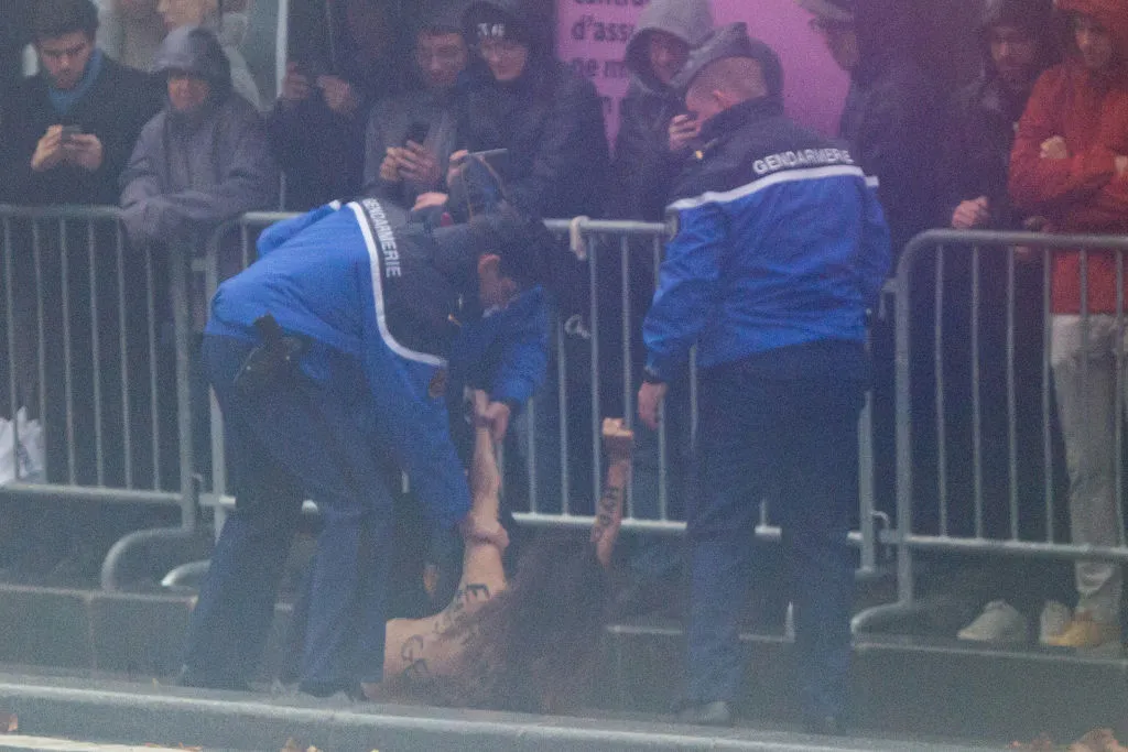 French police tackle a FEMEN protester after she approached the motorcade of the US President at the Arc de Triomphe in Paris, on Nov.&nbsp;11.&nbsp;