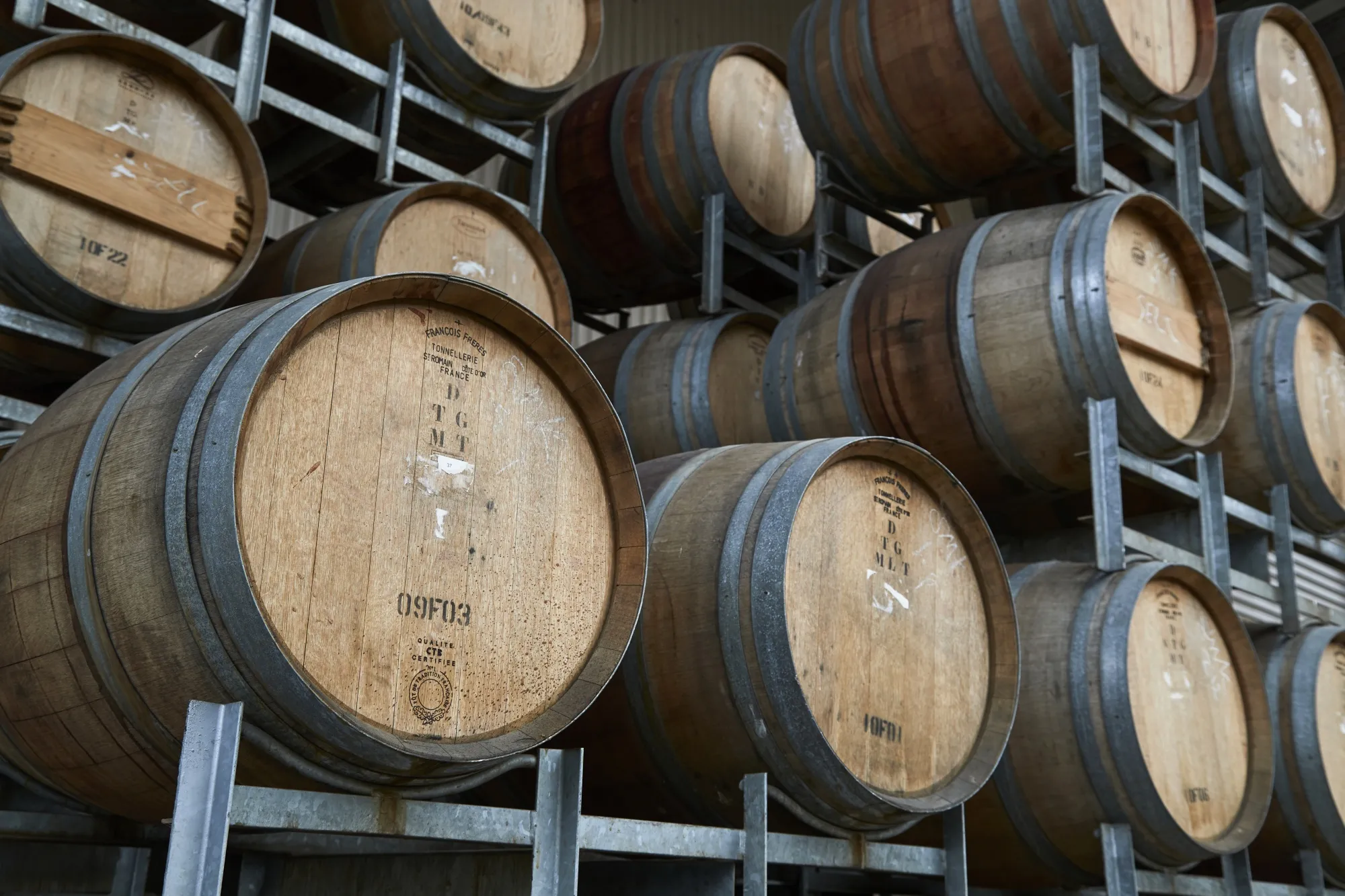 Wine barrels stacked at a winery in the Yarra Valley, Victoria, Australia.