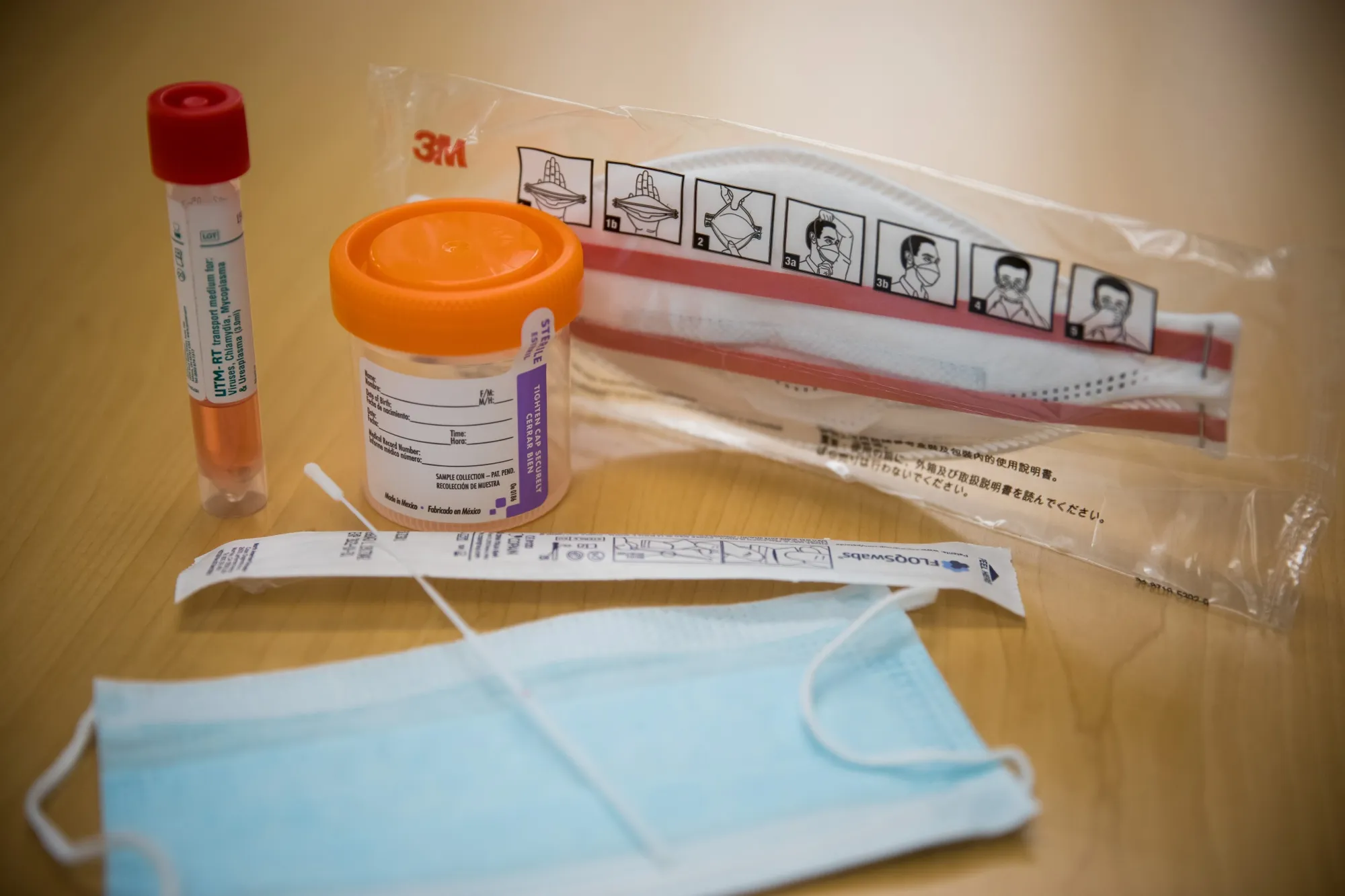 Items from a COVID-19 test kit are displayed for a photograph in New York.