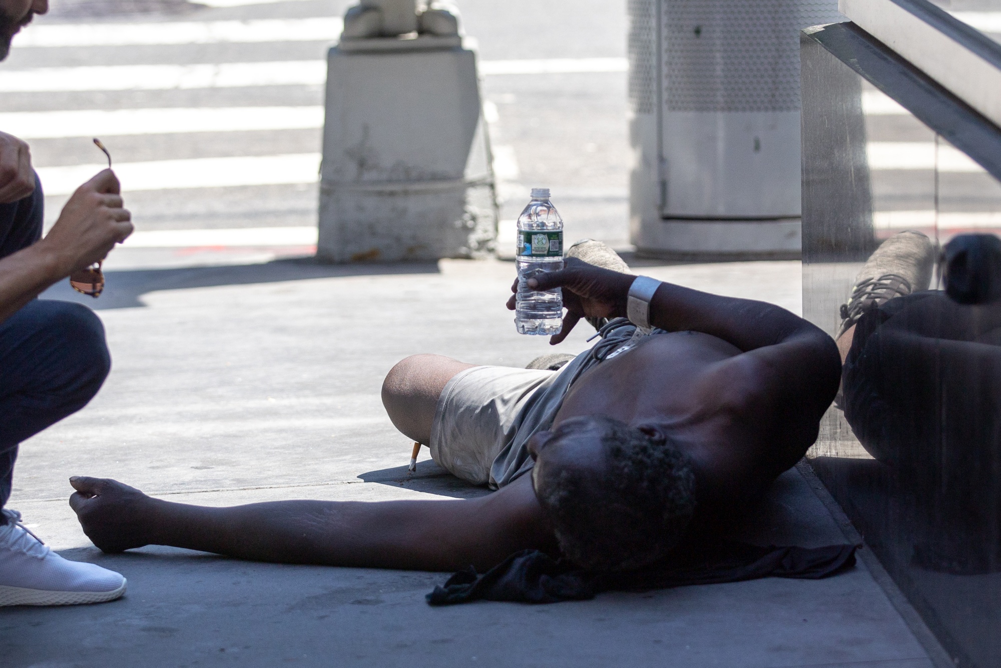 A person lays on the street near Times Square during a heatwave in New York, U.S., on Wednesday, June 30, 2021.