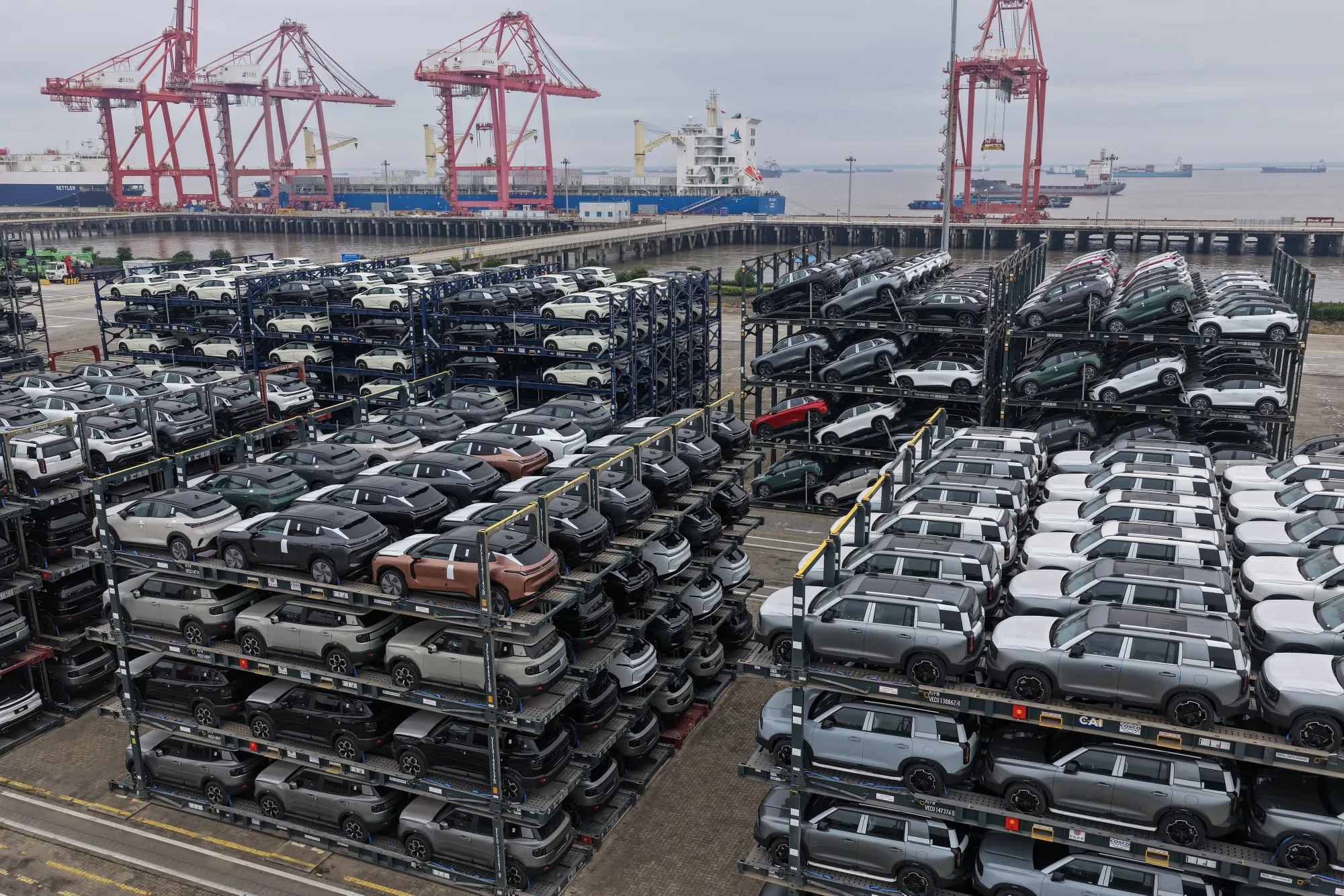 Chinese-made cars are seen in specialised vehicle racks in preparation for loading onto ships for export, at the Taicang Port area of Suzhou Port, in China’s eastern Jiangsu province on October 12, 2026.