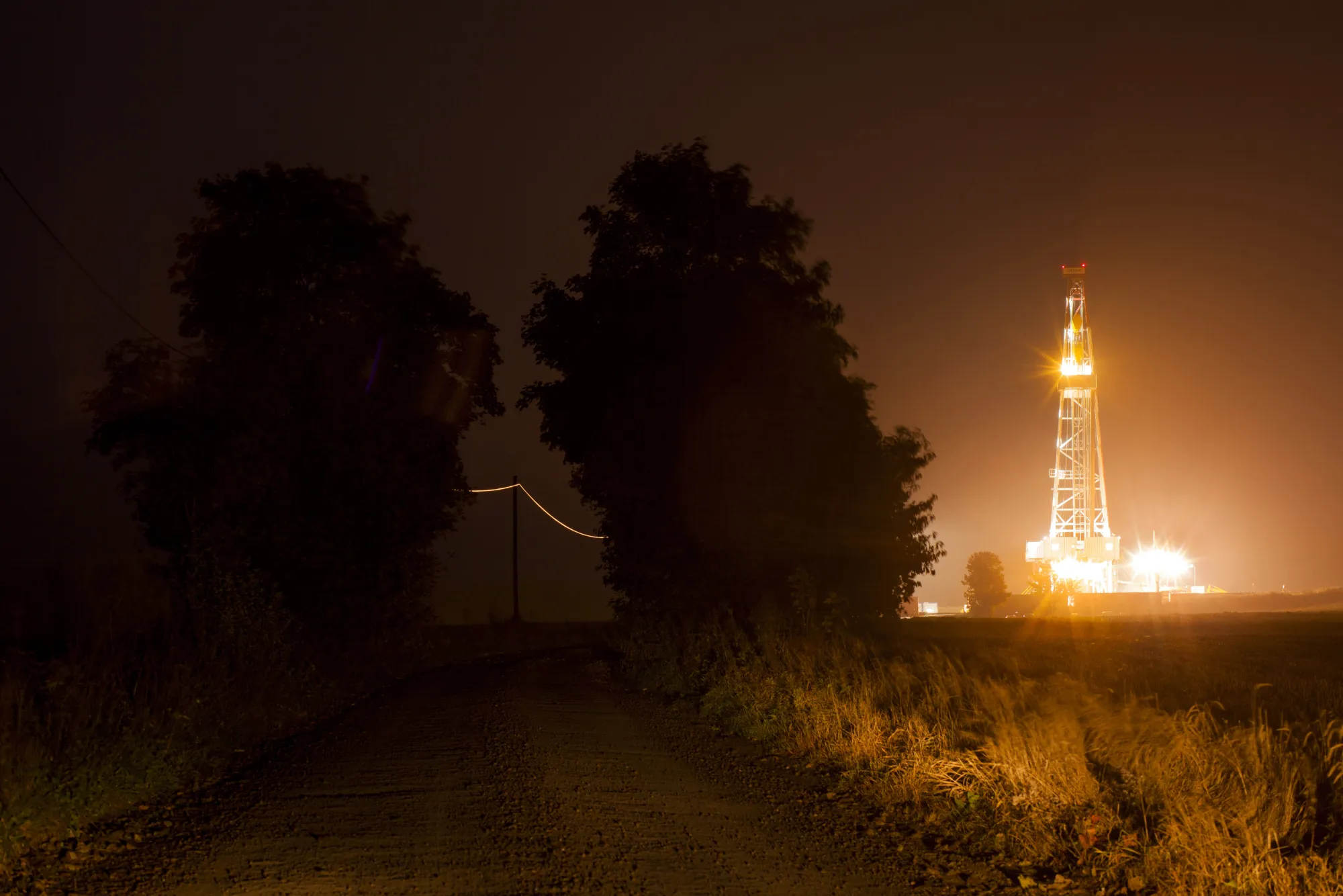 Light illuminates a shale gas drilling rig in Lubocino, Poland.
