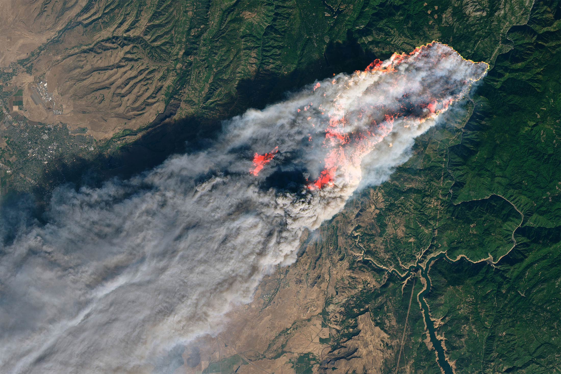 This enhanced satellite image provided by NASA's Earth Observatory, shows a wildfire in Paradise, Calif., on Thursday, Nov. 8, 2018. Flames in the image were enhanced with infrared data. (NASA via AP)