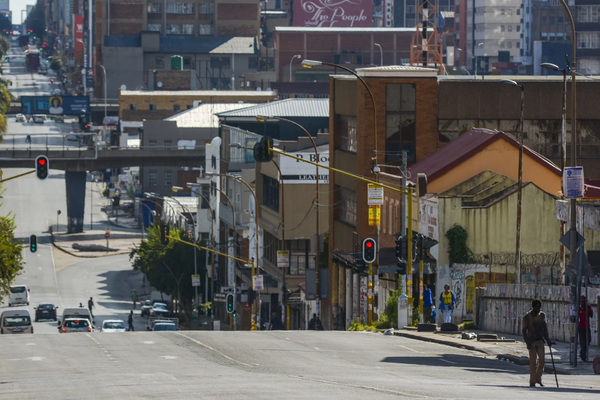 Pedestrians walk along a sidewalk in the the Central Business District of Johannesburg during lockdown.&nbsp;