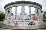The graffiti-tagged pedestal of the Jefferson Davis monument in Richmond, Virginia.