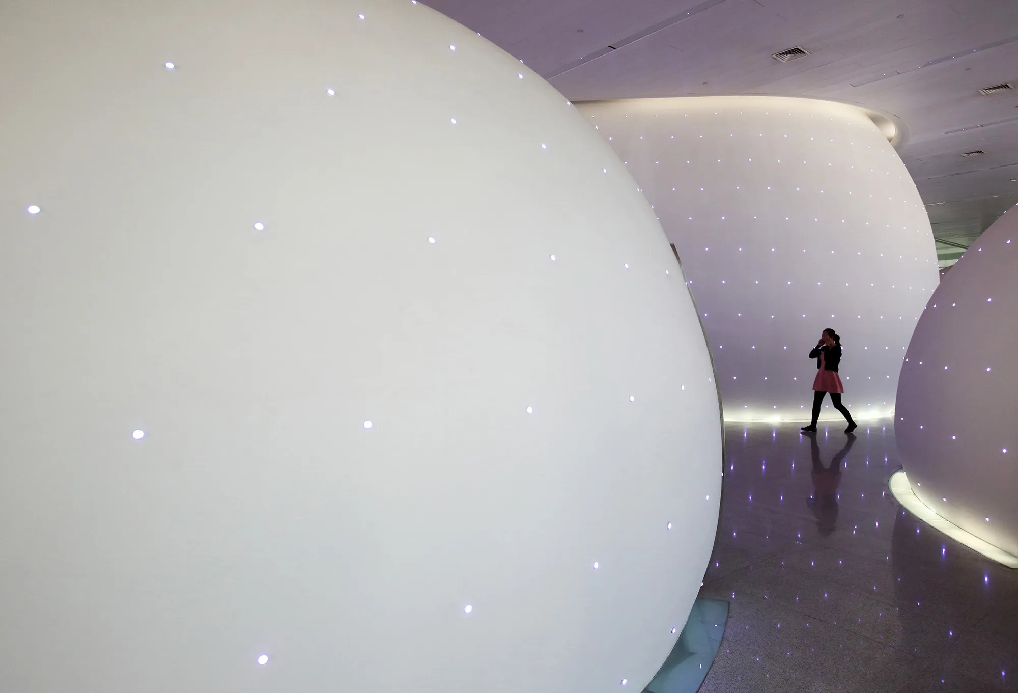 An employee walks past dome structures used as nap rooms in the Baidu headquarters in Beijing.
