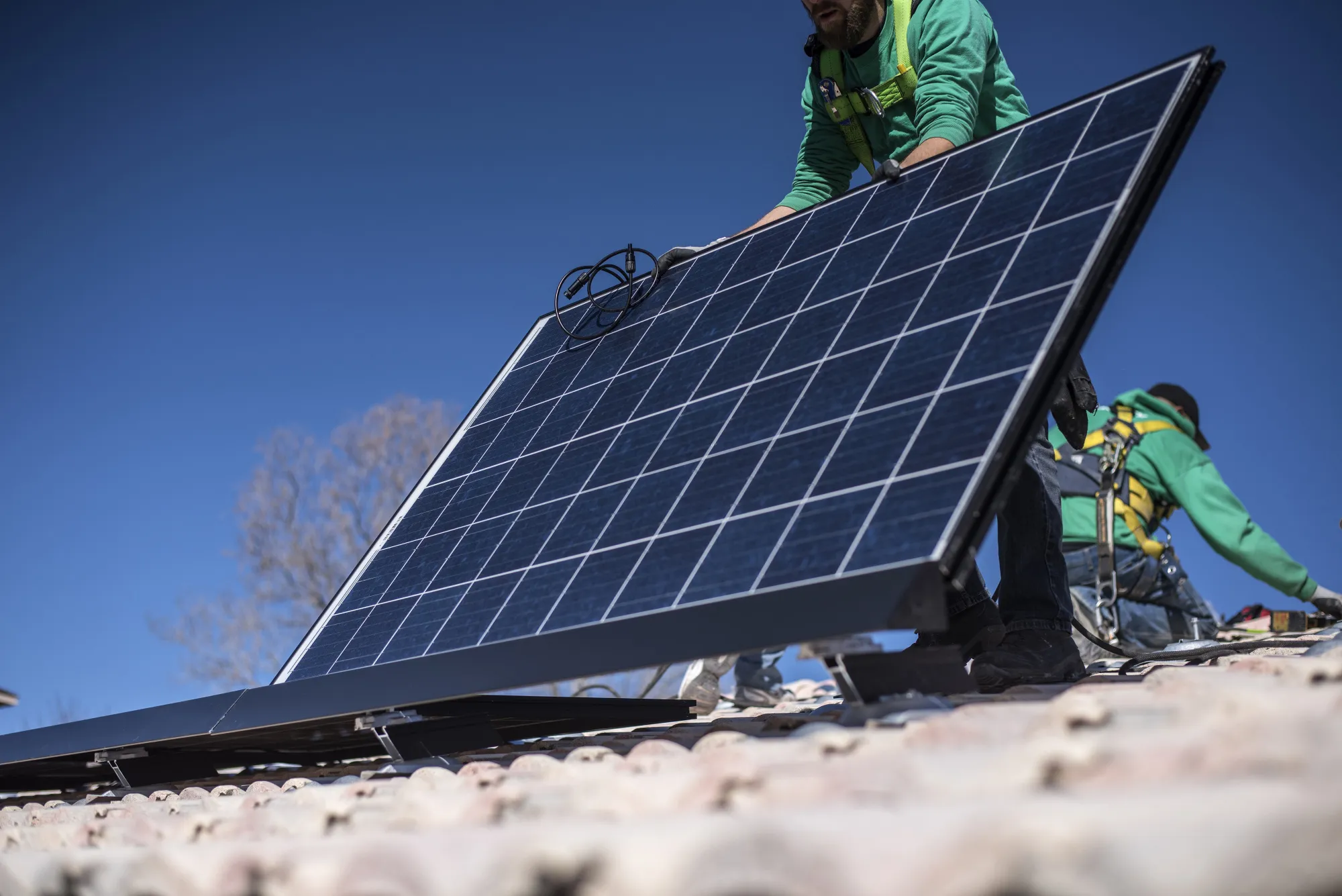 A worker lays down a solar panel in Albuquerque, New Mexico.