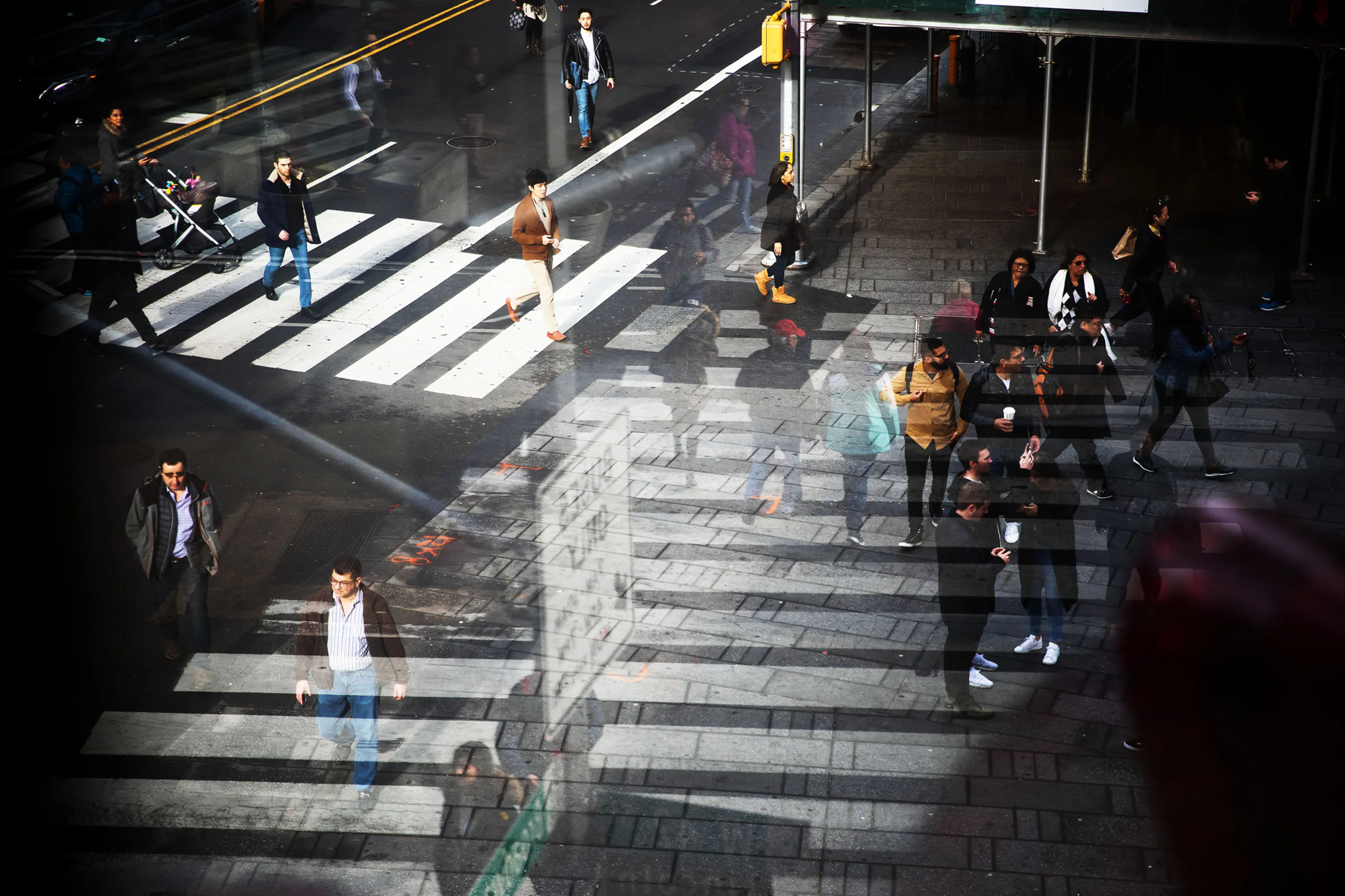 Pedestrians walk though the Times Square neighborhood of New York.