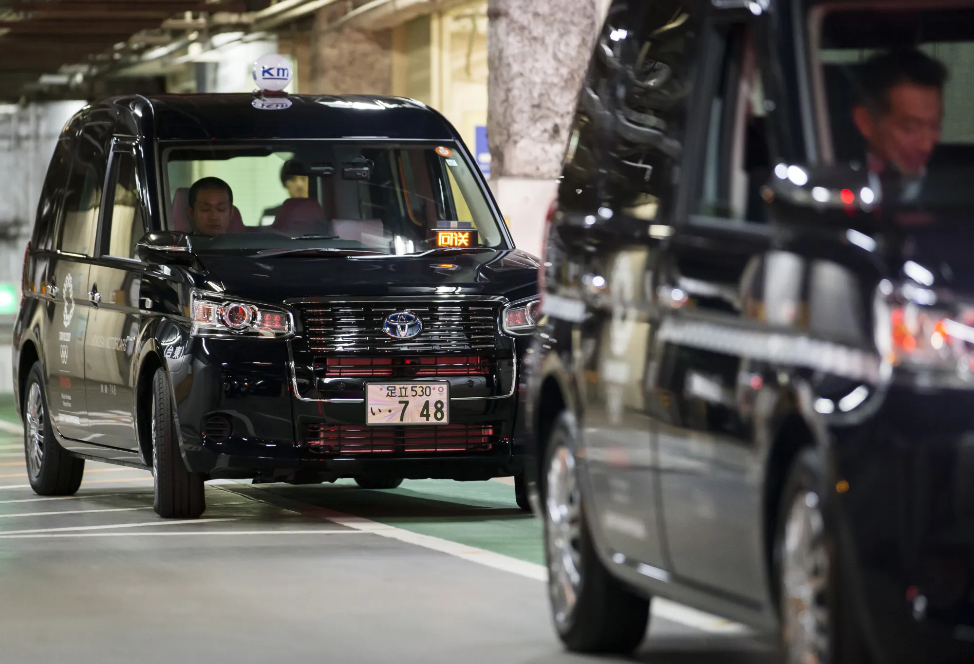 Toyota Motor Corp. JPN Taxi vehicles are driven in a garage following its launch in Tokyo, Japan, on Monday, Oct. 23, 2017. Toyota wants a third of cabs on Tokyo’s streets to be its next-generation taxi by the start of the 2020 Summer Olympics, as it aims to create an icon on par with the yellow cabs of New York and black cabs of London.