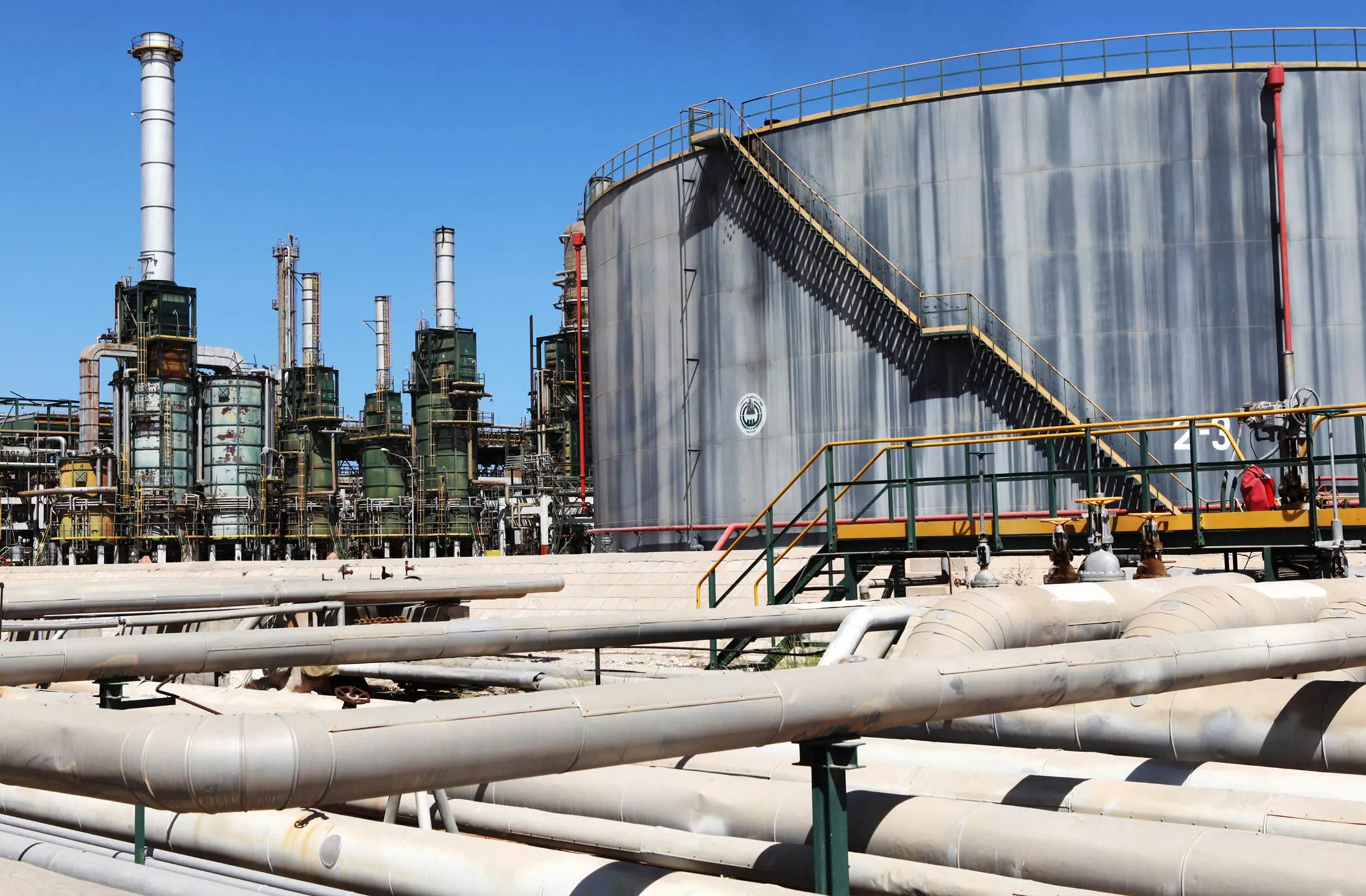 Refining towers and fuel storage tanks are seen at the Zawiya oil refinery near Tripoli, Libya, on Monday, Aug. 29, 2011.
