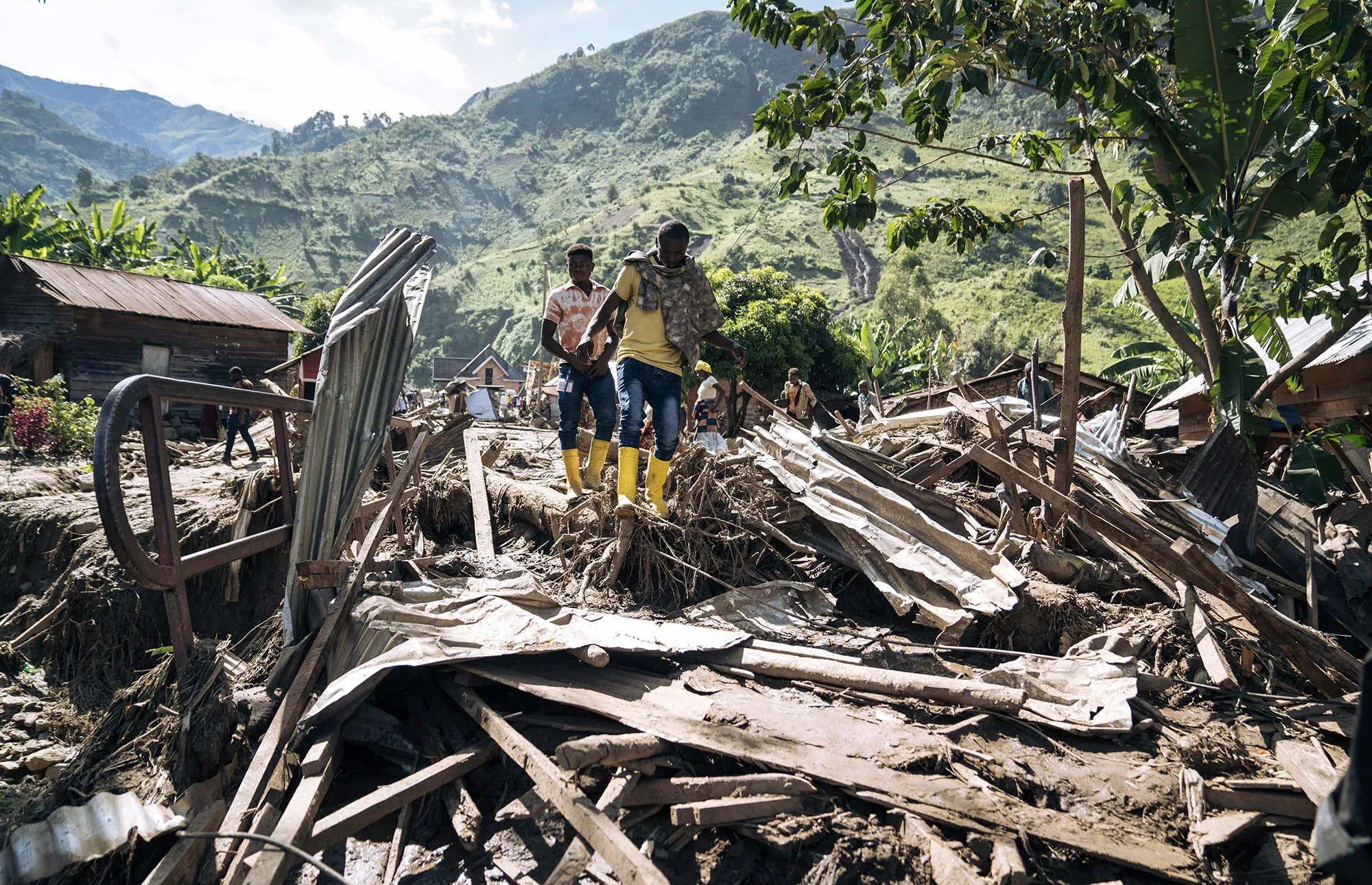 Residents of Nyamukubi walk through the rubble after heavy flooding in eastern Democratic Republic of Congo, on May 6.