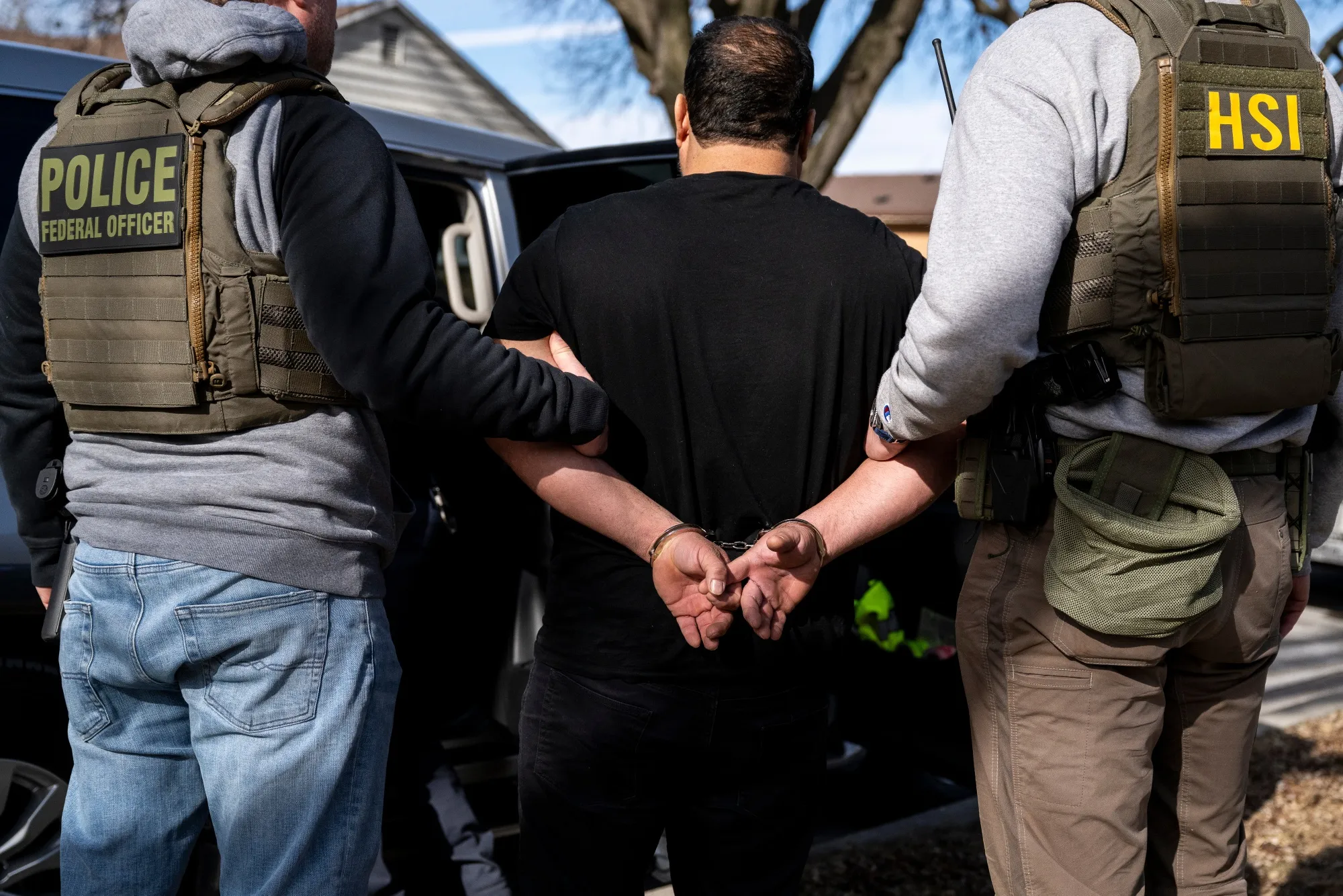 US Immigration and Customs Enforcement agents detain a suspect during a multi-agency targeted enforcement operation in Lyons, Illinois.
