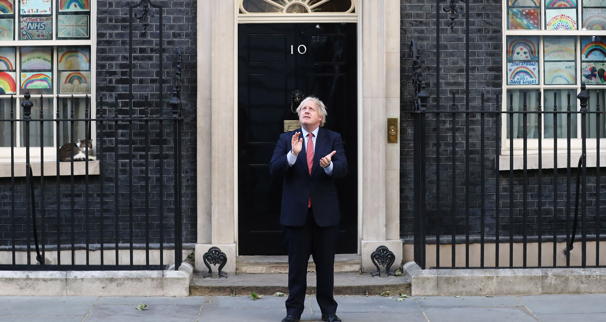 Boris Johnson claps while standing outside 10 Downing Street during a national round of applause to show appreciation for health workers in London on&nbsp;June 28.&nbsp;